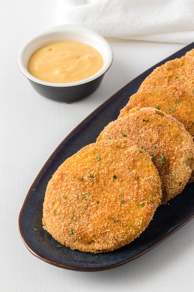 A summer side dish of green fried tomatoes.