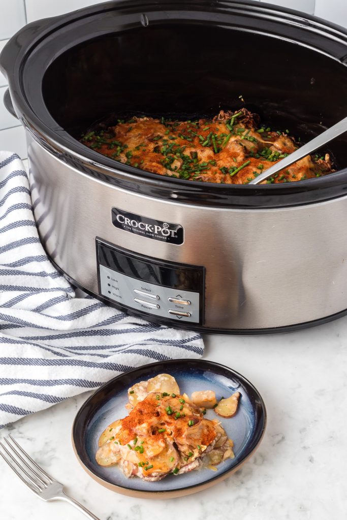 Red scalloped potatoes made in a Crockpot.