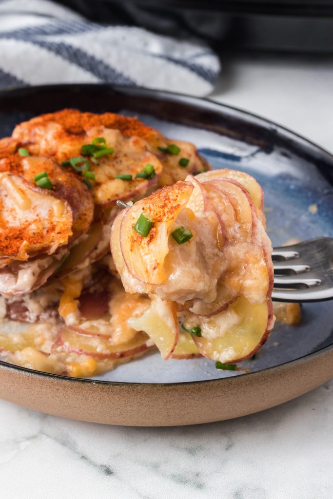 A bite of a slow cooker potato side dish.