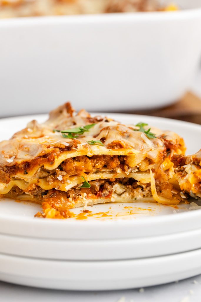 A bite taken out of a slice of lasagna.