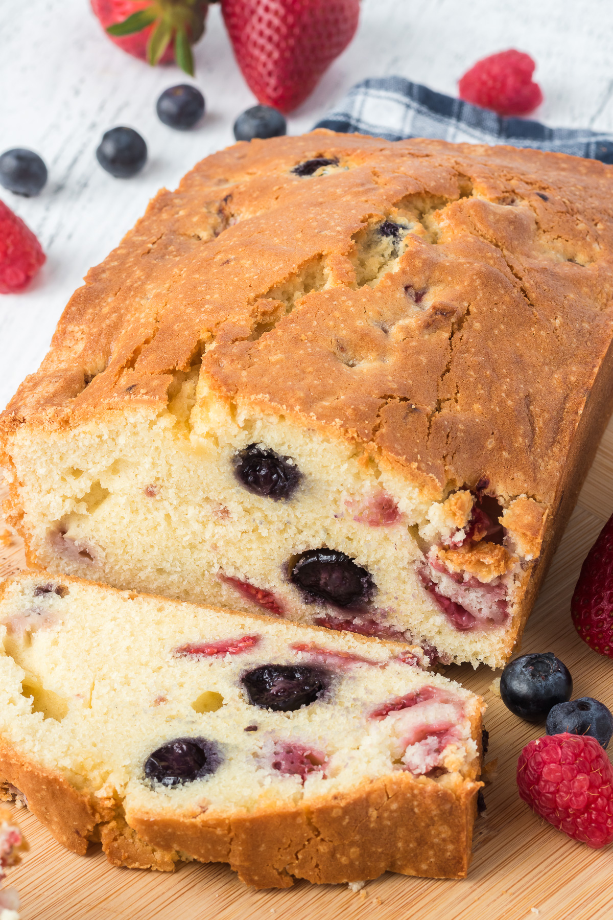 This Triple Berry Bread is bursting with flavor from fresh summer berries like raspberries, blueberries, and strawberries. It is perfect for everyone in your whole family. via @foodhussy