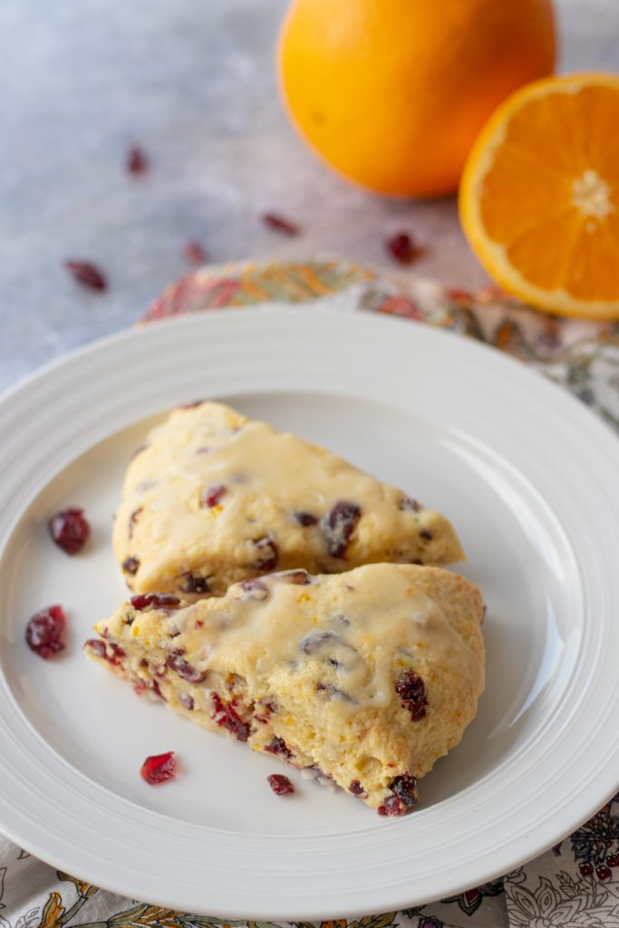 Two orange scones with dried cranberries.