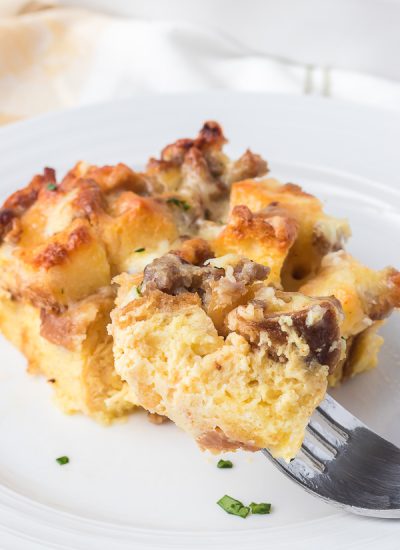 A bite of a breakfast casserole with sausage.