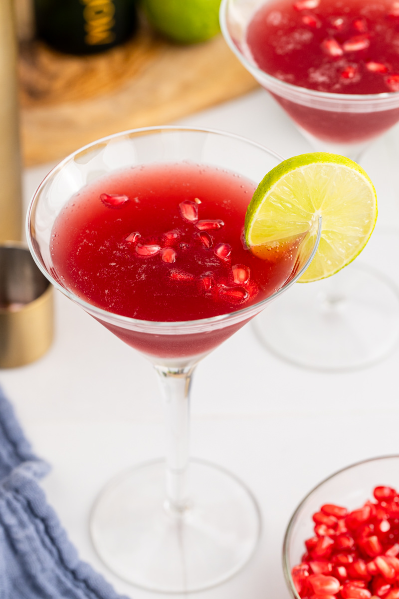 A Pomegranate Lime Martini is a festive cocktail full of fresh pomegranate juice, bubbly champagne, and more. Make this party cocktail this holiday season to celebrate New Year’s Eve or any occasion! via @foodhussy