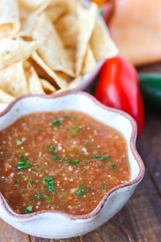 A bowl of fresh salsa made with tomatoes and tomatillos.