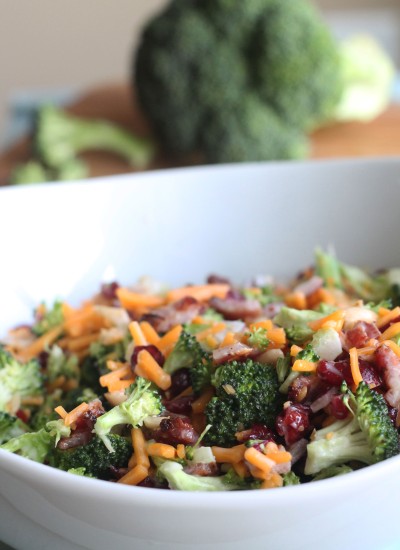 Need an easy side dish? Make this Creamy Broccoli Salad! It's full of fresh broccoli, cheese, red onion, dried cranberries, almonds and bacon mixed in a creamy, delicious dressing.
