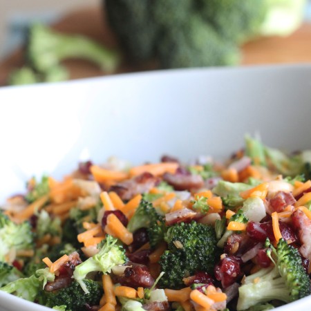 Need an easy side dish? Make this Creamy Broccoli Salad! It's full of fresh broccoli, cheese, red onion, dried cranberries, almonds and bacon mixed in a creamy, delicious dressing.