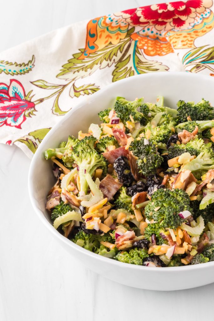 Broccoli, cheese, almonds, bacon, dried cranberries, celery, and onion make for an easy salad.