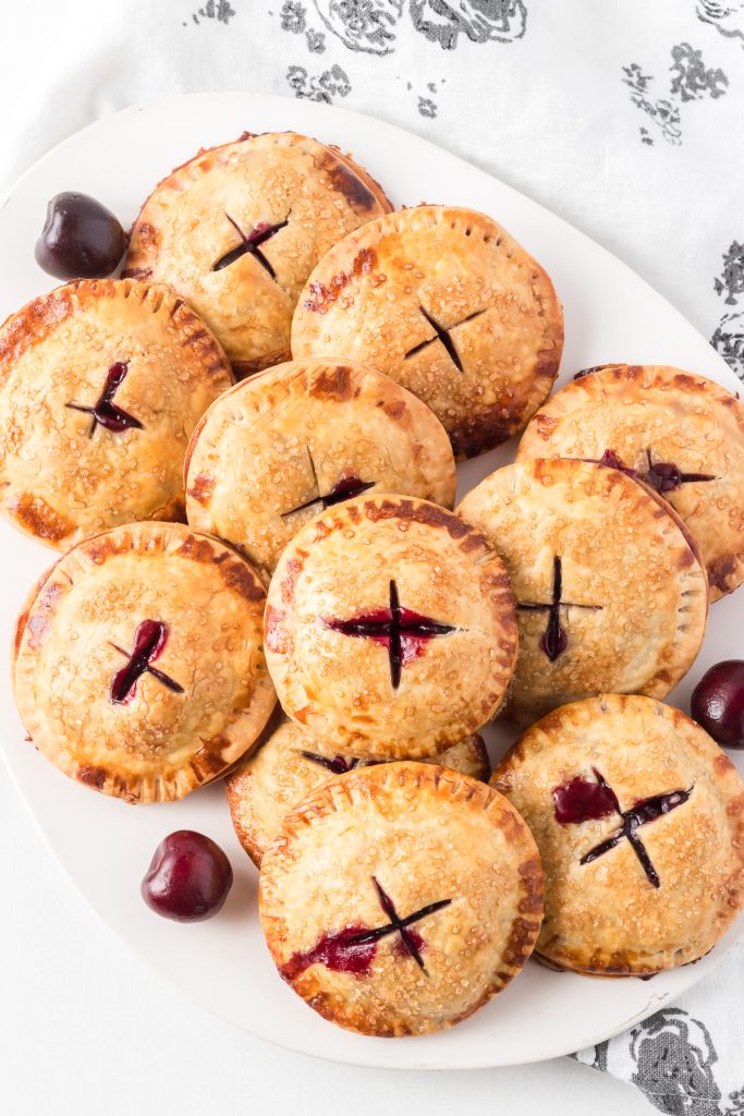 A plate of individual cherry pies.