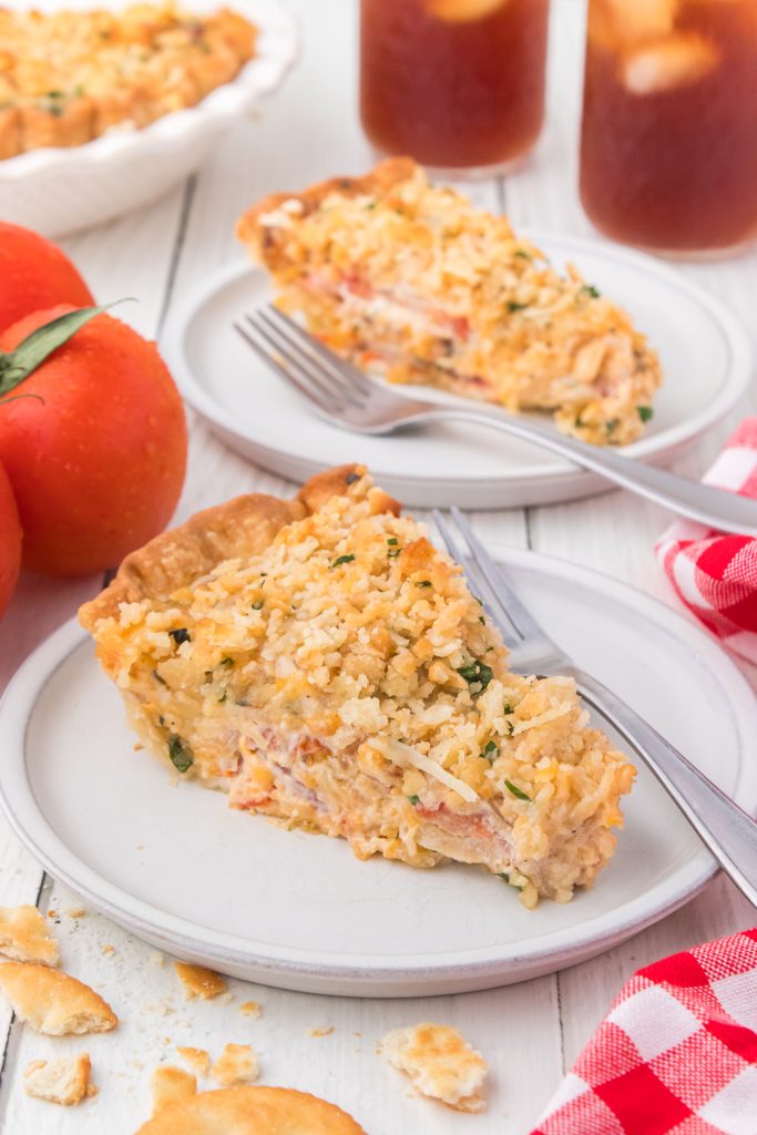A cheesy Ritz cracker topping on top of a tomato savory pie.
