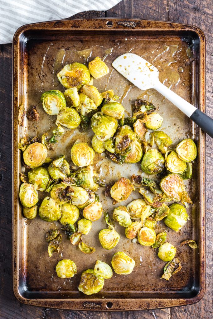 Coating sprouts with a dijon honey mustard sauce.
