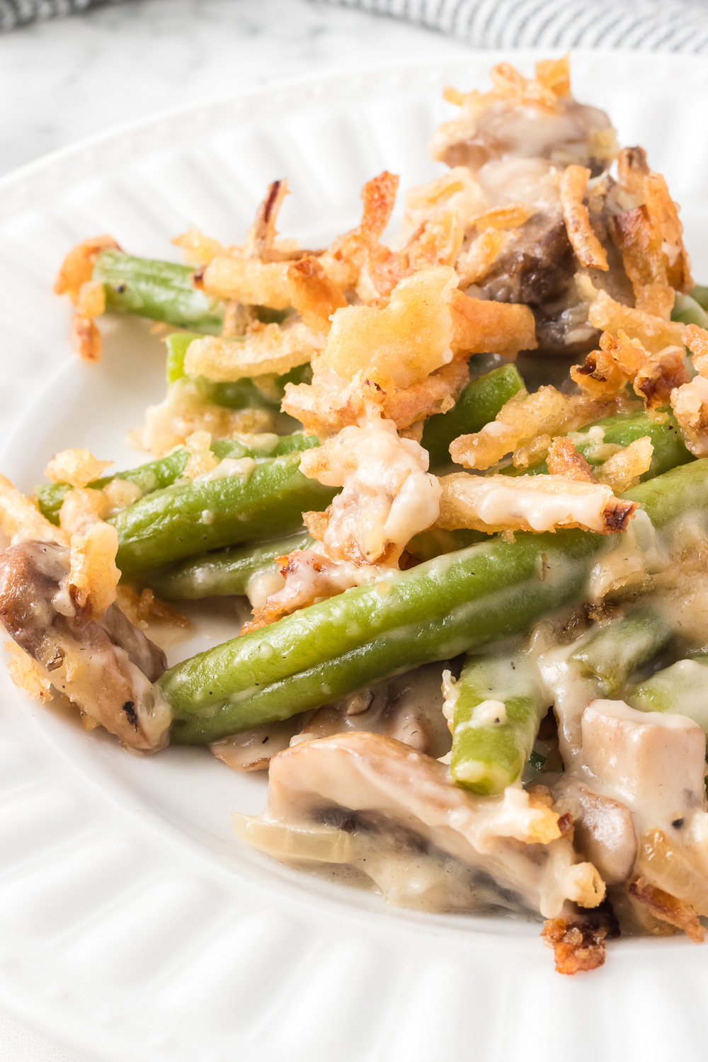 This upscale version of the classic Green Bean Casserole takes the flavors of a holiday standby and elevates it with fresh, flavorful ingredients! Tender green beans are combined with onions and mushrooms in a savory cream sauce. Sub out the canned French onion topping with hand-fried shallots for crunch, and you have the perfect side dish for your meal! via @foodhussy