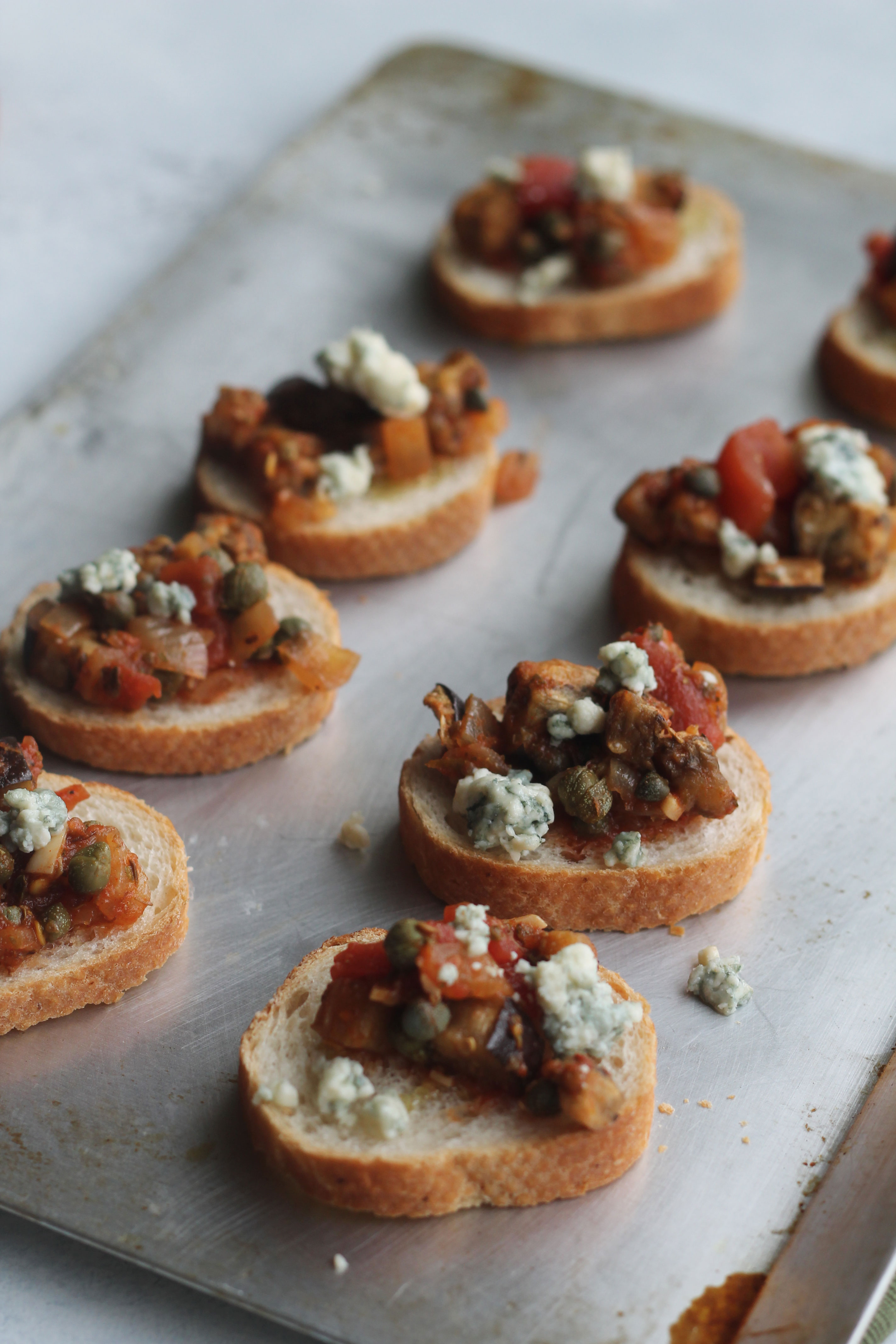 Bruschetta with eggplant, capers and blue cheese crumbles make this the perfect appetizer
