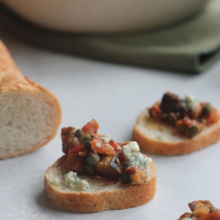 Eggplant, tomatoes, onions, and capers give this delicious bruschetta a twist!