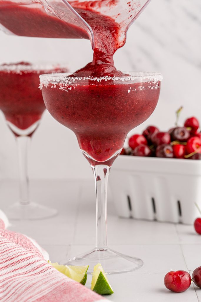 Pouring an ice cold frozen Margarita made of cherries.