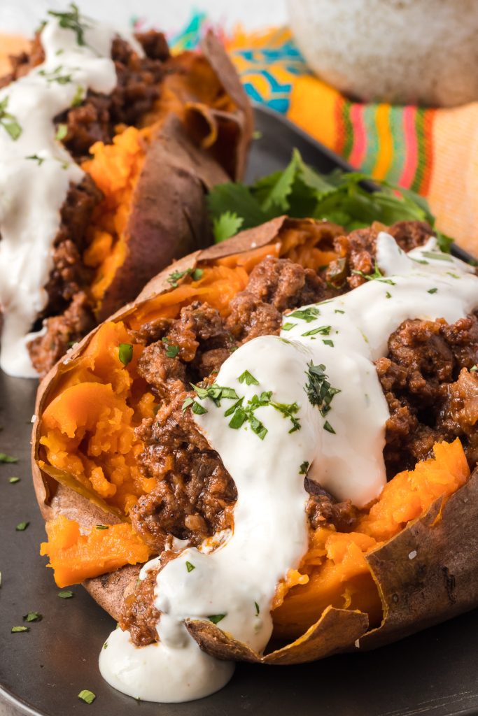 Sweet potatoes filled with taco meat and covered with a lime crema.