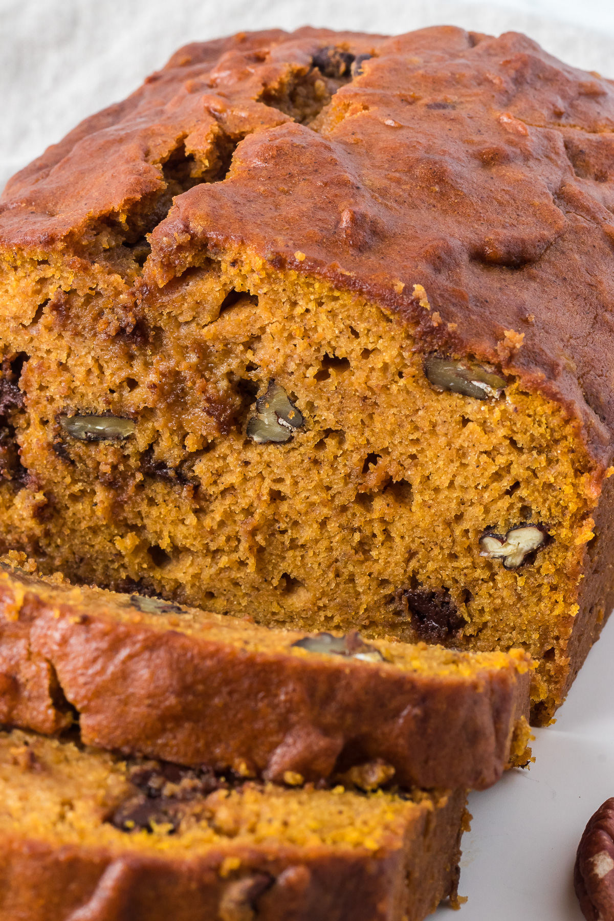 Enjoy a warm loaf of this Pumpkin Chocolate Chip Bread any time of the year! Who says pumpkin is only for fall? Make a batch of this delightful bread whenever you are craving the warm spices of pumpkin bread. This quick bread recipe adds a twist with melty chocolate chips and optional crunchy pecans, too! via @foodhussy