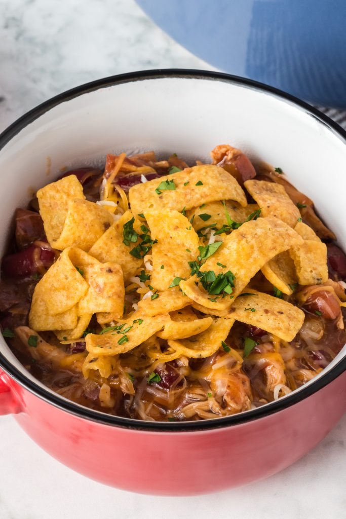 Fritos corn chips top a hearty bowl of chicken chili.
