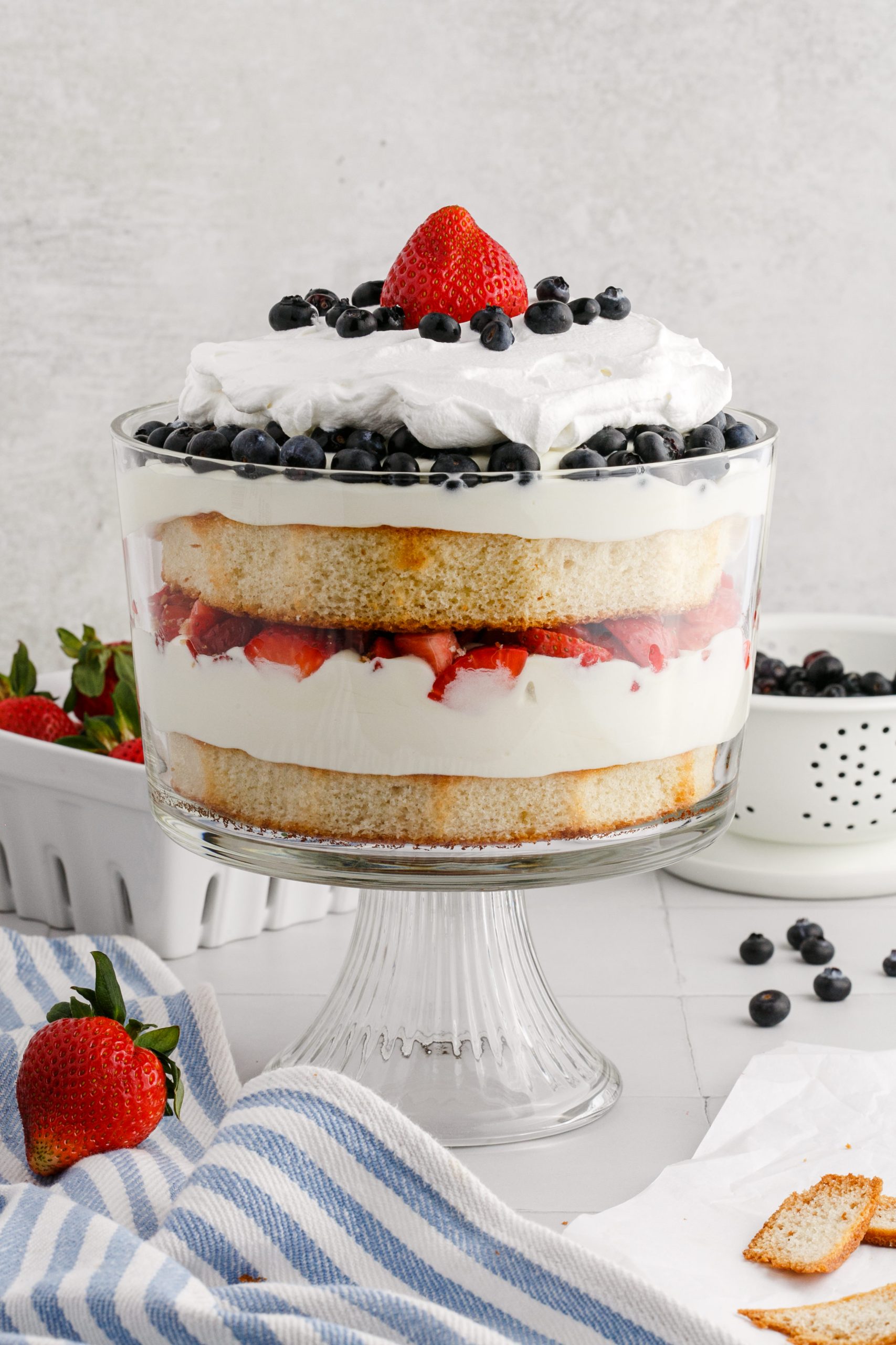 Celebrate patriotic holidays with this no bake dessert, a 4th of July Trifle. This easy red, white and blue dessert made with fresh berries, cake, pudding, and Cool Whip will be one of the highlights of the dessert table and is perfect for a summer party. via @foodhussy