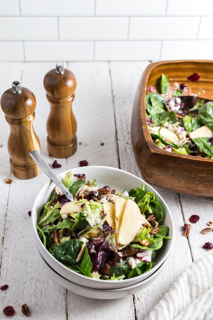 Salad with chicken, apples, pecans, and cranberries.