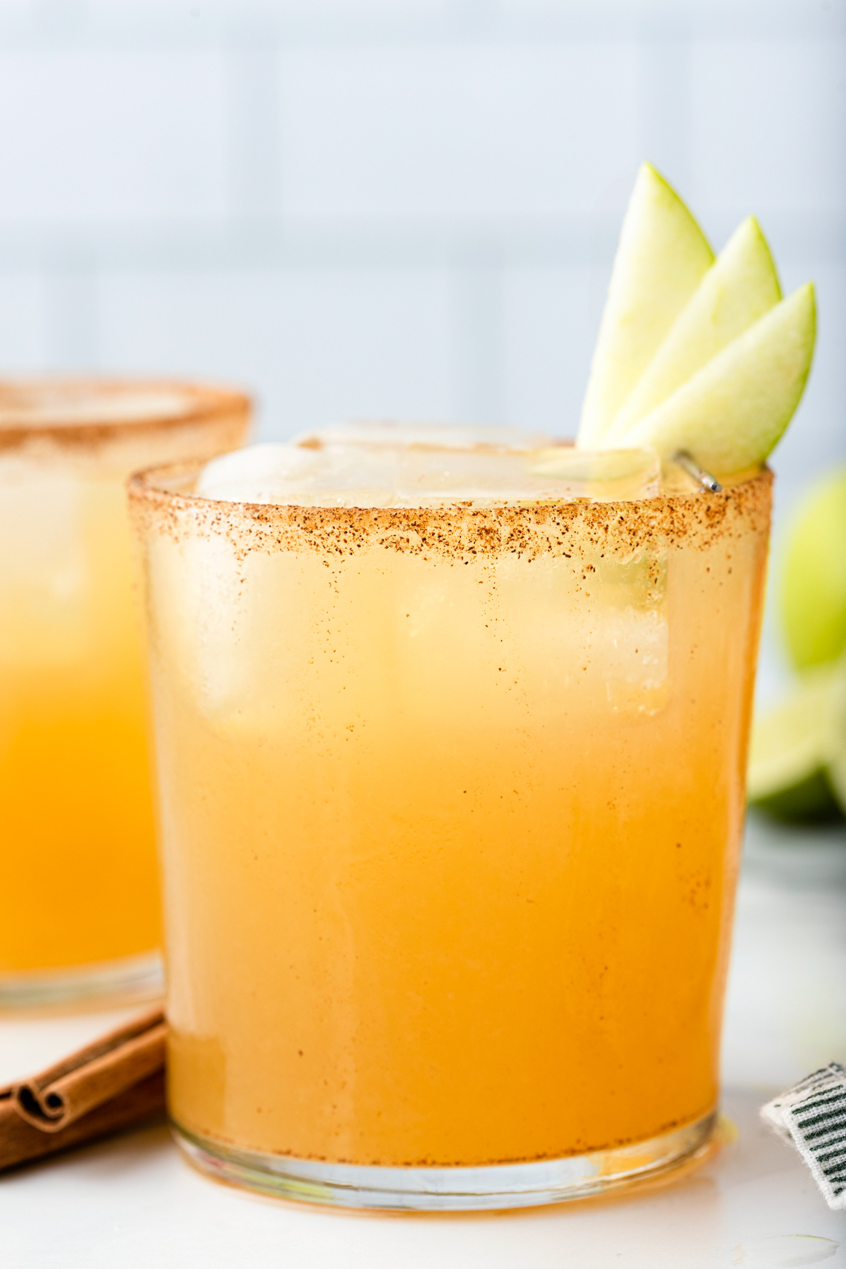 This spiced Apple Cider Margarita will become one of your favorite fall cocktails! Whether you need the perfect drink for your party or just something to enjoy with a loved one on chilly fall evenings, this delicious cocktail will bring a smile to your face and warmth to your soul! via @foodhussy