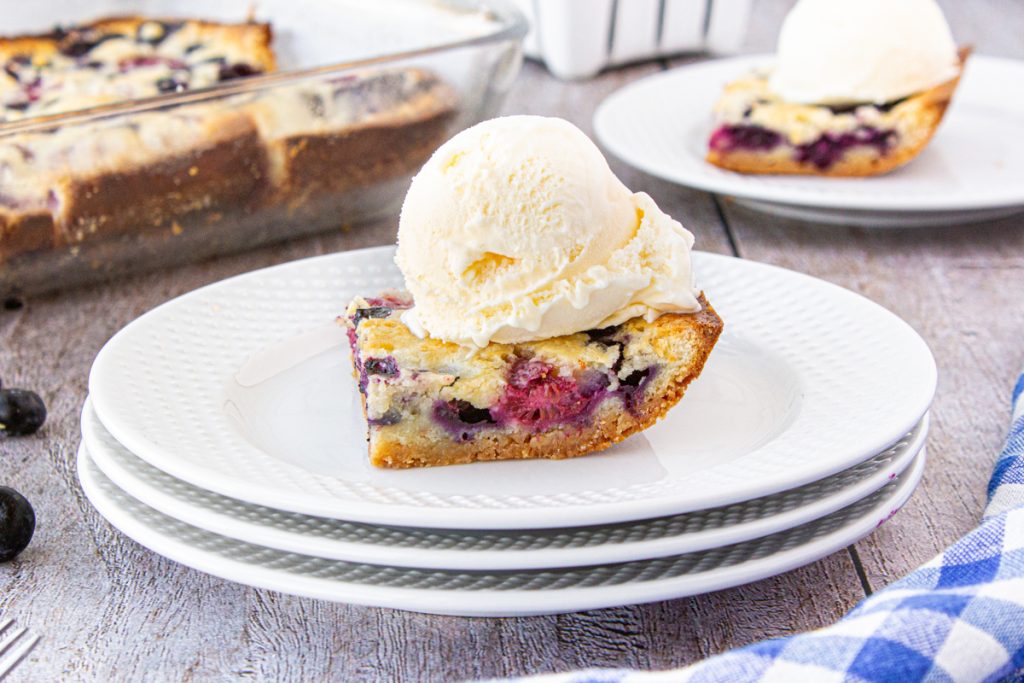 Mixed Berry Pie Bars topped with ice cream. 
