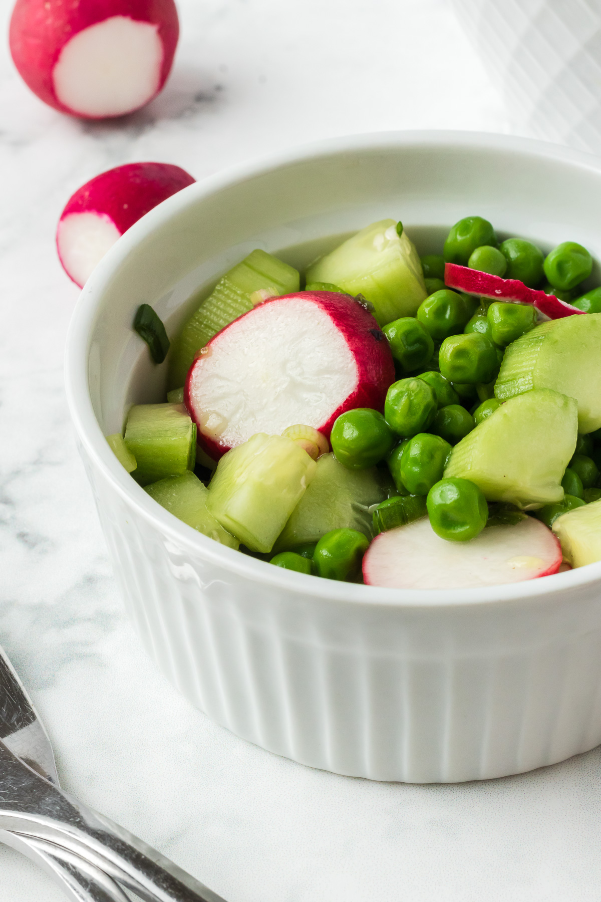This light and refreshing Crunchy Pea Salad combines sweet peas, crunchy radishes, and cucumbers tossed in a sweet and tangy vinaigrette. It’s the perfect lunch on a hot summer day! via @foodhussy